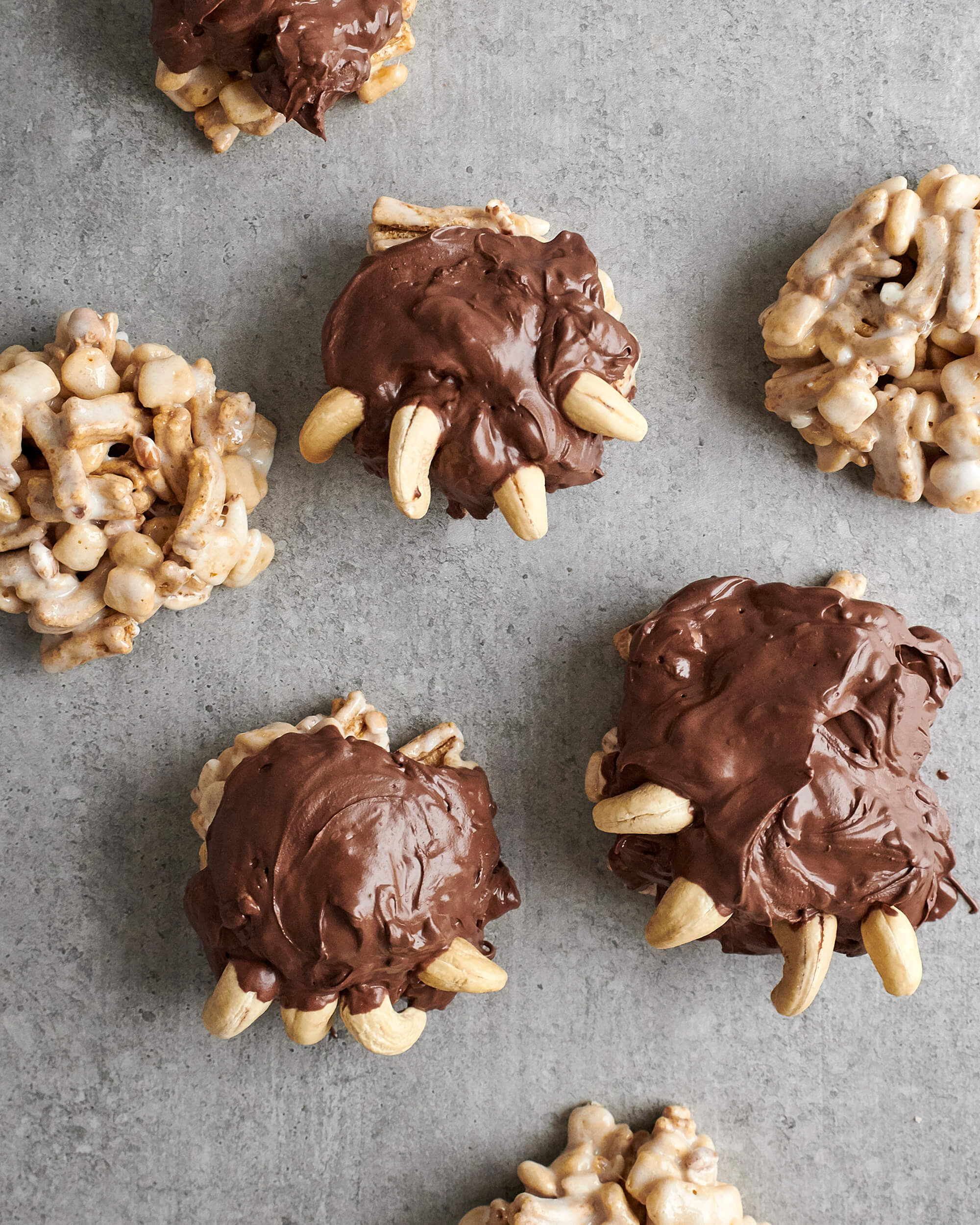 Photo du dessert « pattes de grizzli ». On voit des bouchées de céréales à la guimauve recouvertes de chocolat. Et des noix de Cajou ont été stratégiquement placées pour créer 4 griffes sur chacun de ces bouchées.